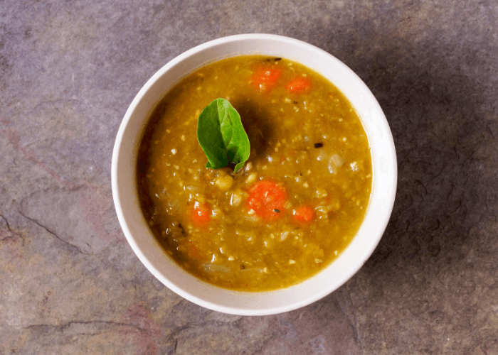 Bowl of Split Pea Soup with Roasted Carrot with a leaf