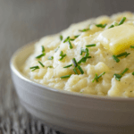 Creamy Mashed Parsnips with butter and chopped green onions in a bowl.