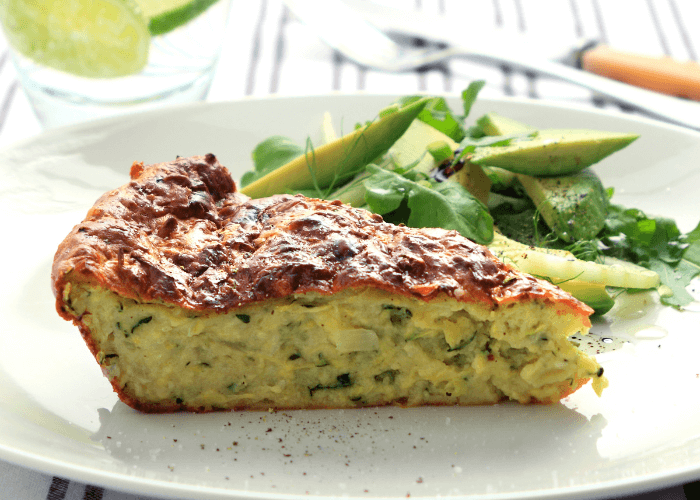 One piece of zucchini pie on a white plate.