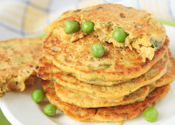 Stacks of pea pancakes with peas on top