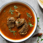 A bowl of goat stew in a bowl.