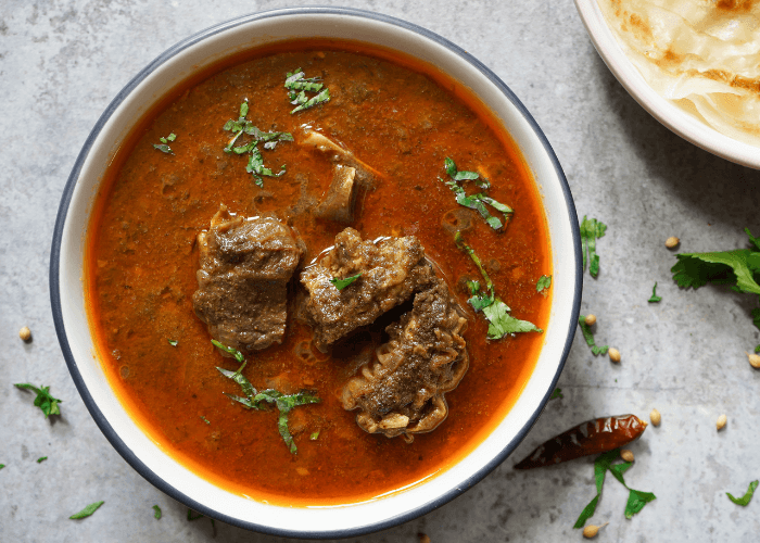 A bowl of goat stew in a bowl.