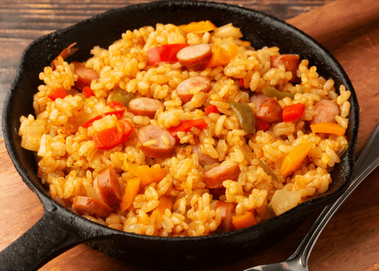 Jambalaya rice, veggies, and sausage in a cast iron pan