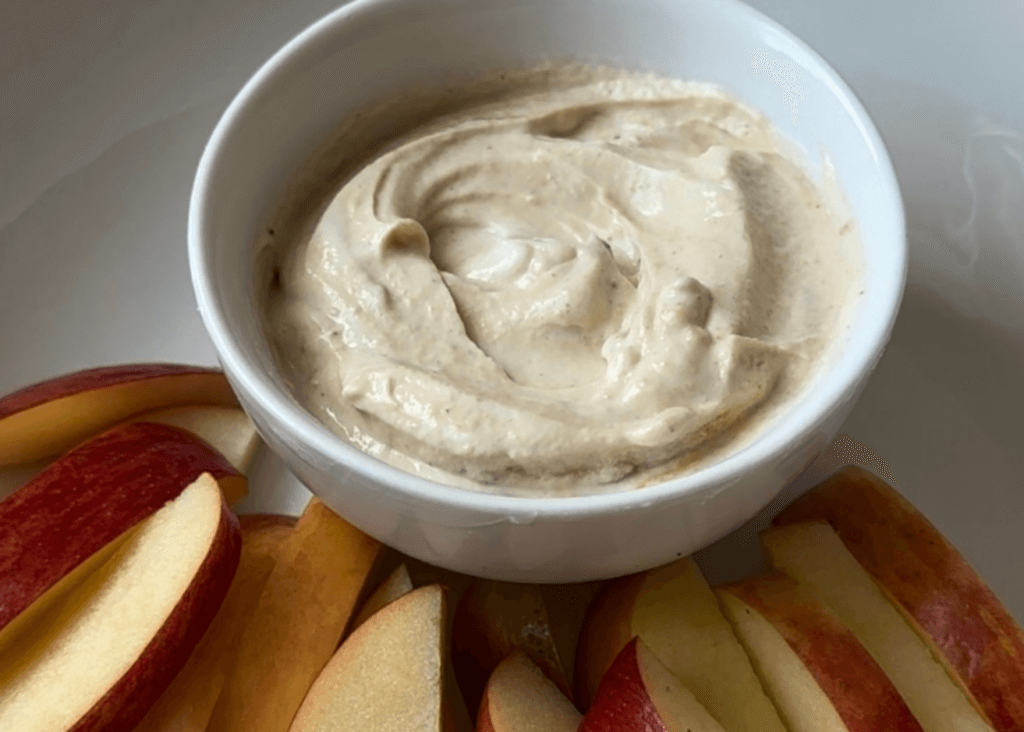 Yogurt Dip in a white bowl with sliced apples