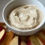 Yogurt Dip in a white bowl with sliced apples