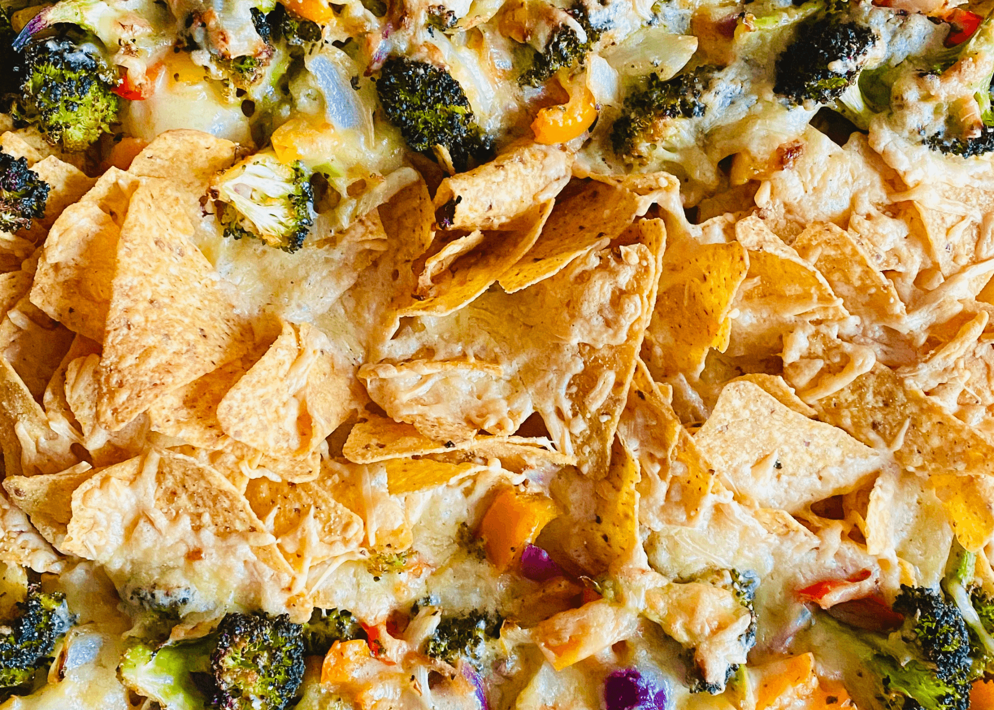 Broccoli Nachos with melted cheese and peppers