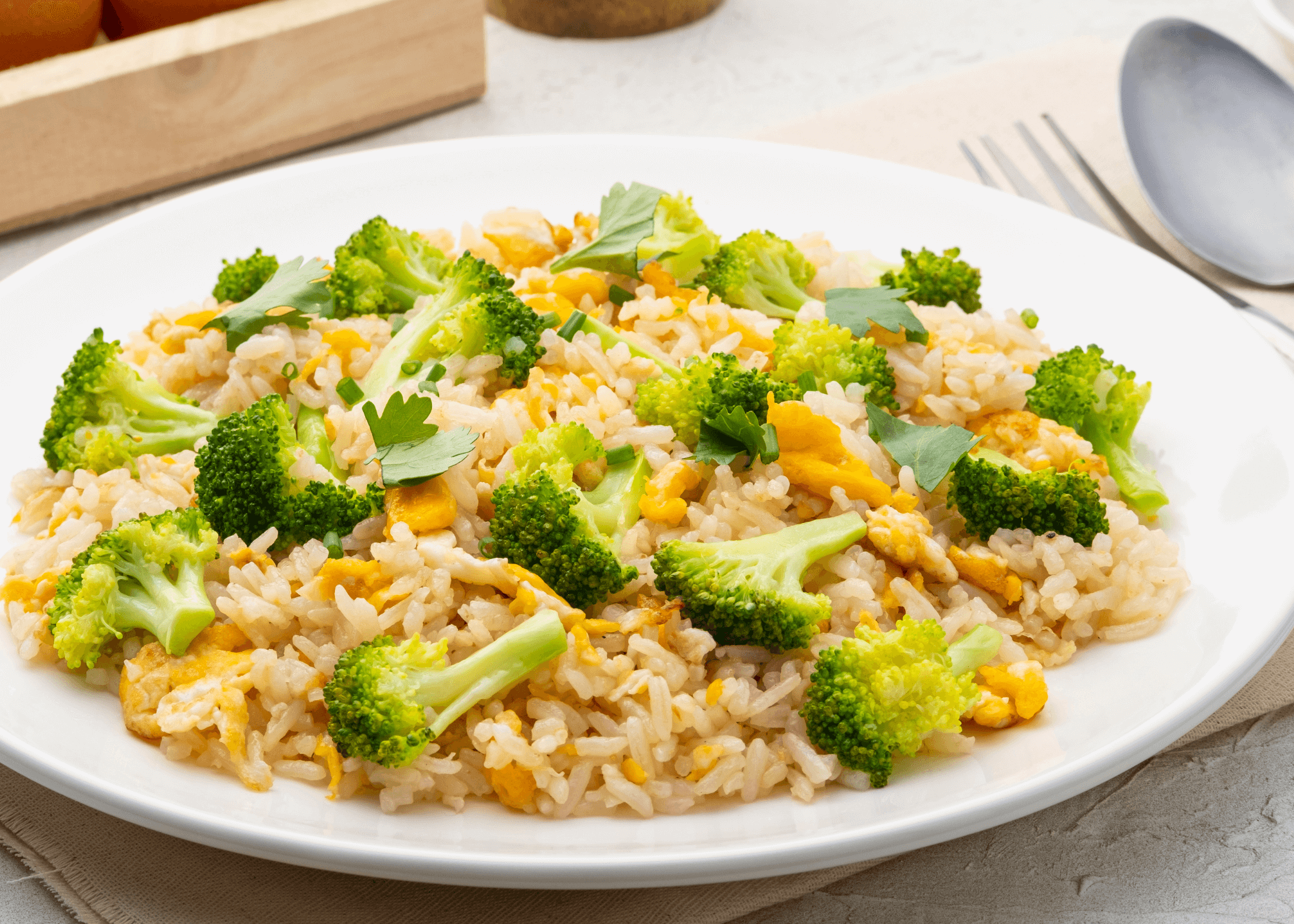 Fried rice with broccoli on a white plate