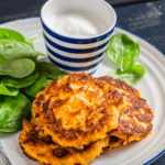 spinach and potato pancakes with baby spinach and glass of milk