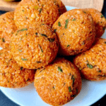 Lentil Meatballs stacked on a white plate