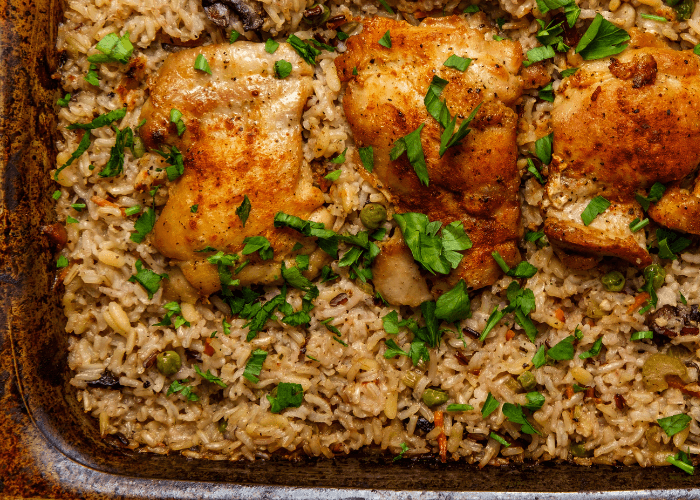 baking dish with chicken thighs and brown rice