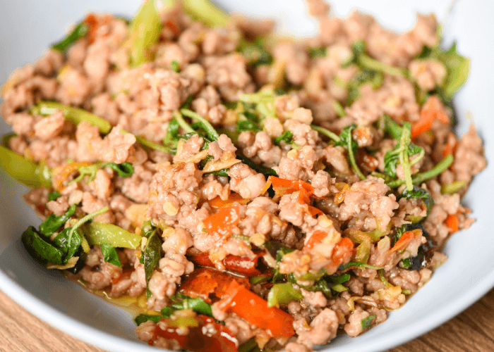 Ground turkey stir fry in a bowl with cooked veggies
