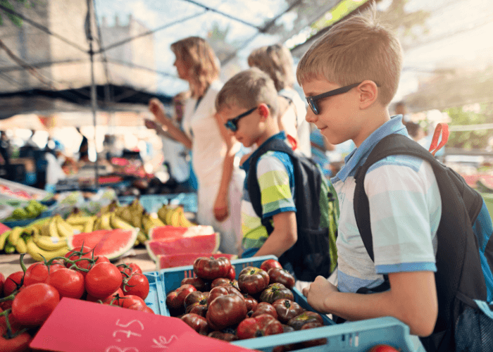 Children shopping at the farmers market