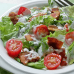 Salad with lettuce, tomato, bacon and dressing