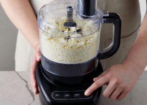 Person touching food processor button