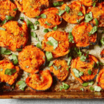 Smashed Carrots on a baking sheet with seasonings