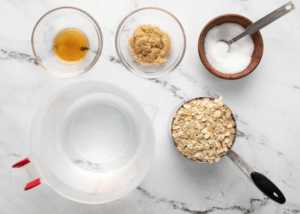 Water, oats, maple syrup, brown sugar ingredients in bowls