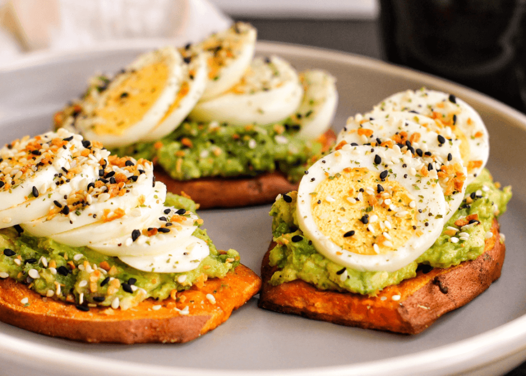 Sweet Potato slices with avocado, egg, and seasonings