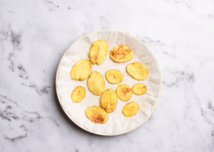 Sliced potatoes on a white plate