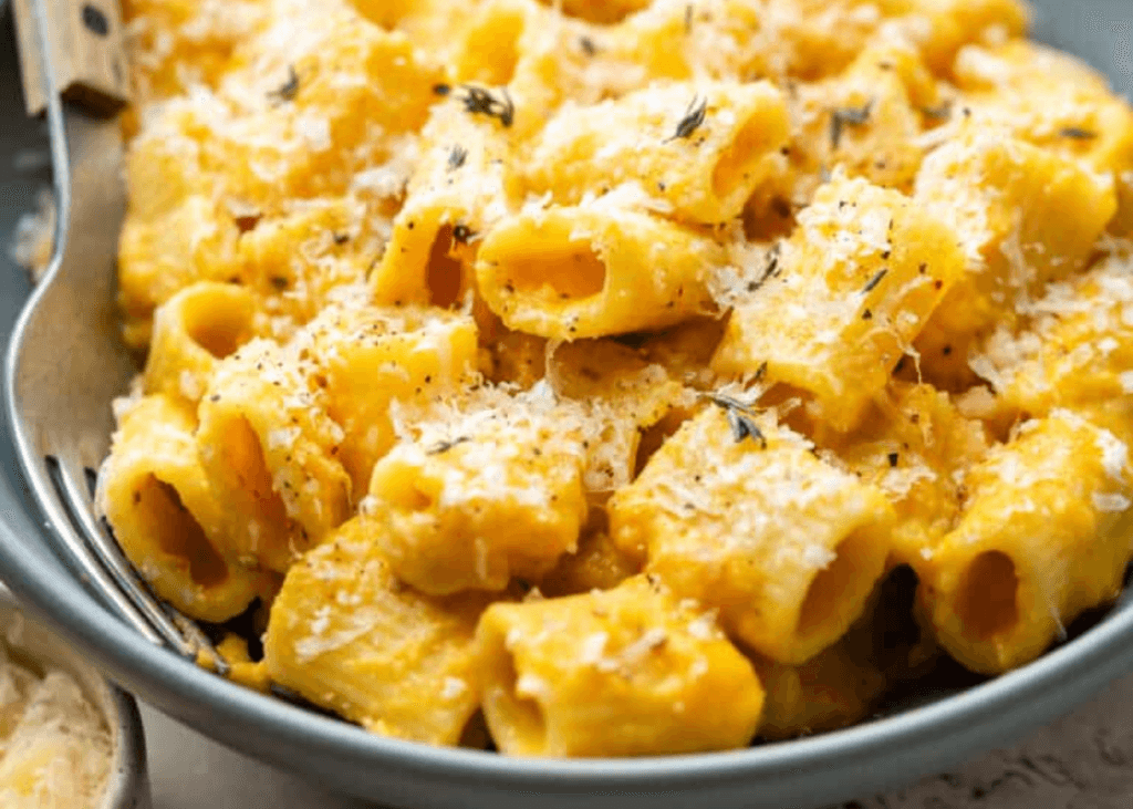 Butternut Squash Mac and Cheese with a fork in a black bowl