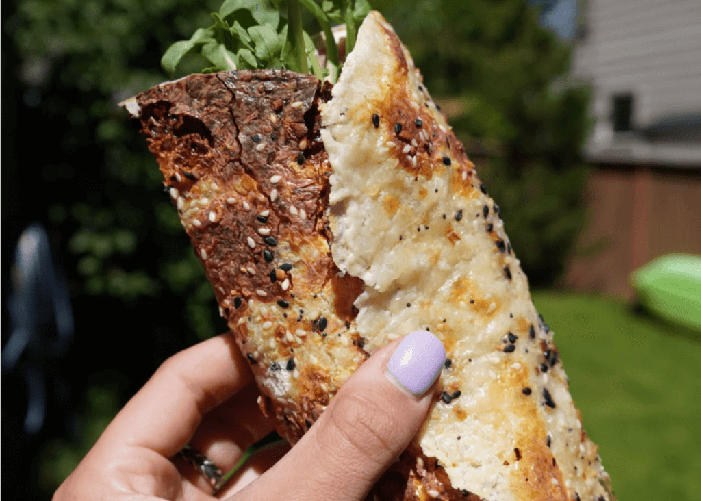 hand holding Cottage Cheese Wrap with lettuce