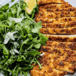 Sliced Chicken Milanese with arugula salad