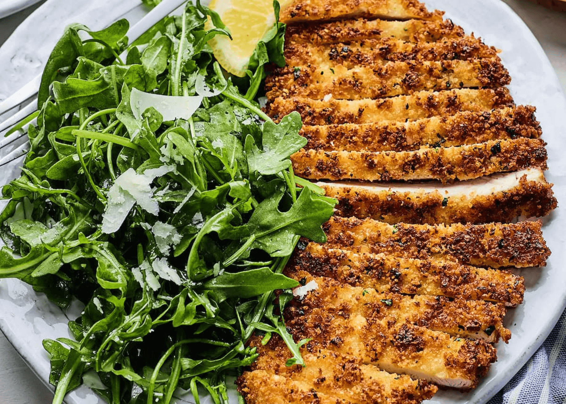 Sliced Chicken Milanese with arugula salad