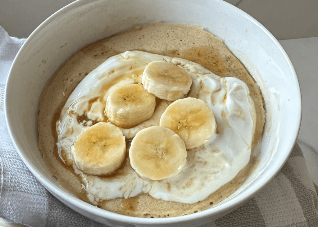 Pancake in a bowl with Greek yogurt and banana slices