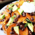 Loaded Sweet Potato Nachos with black beans, sour cream, and chopped avocado