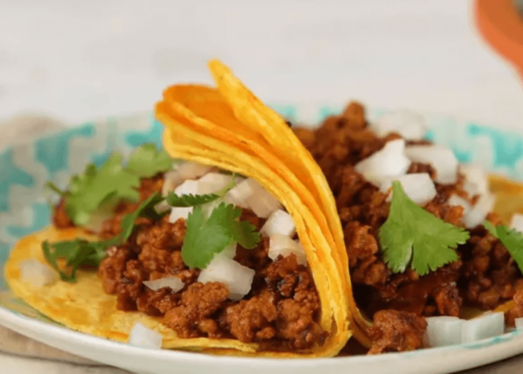 two Chorizo Street Tacos with onions on tortilla shells