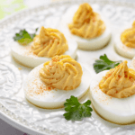 deviled eggs on a white platter