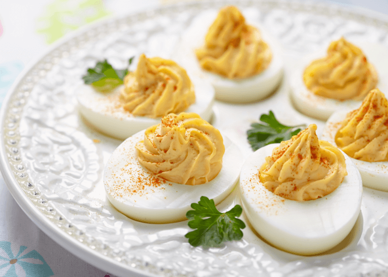 deviled eggs on a white platter